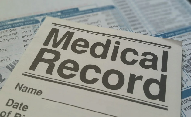 Close up of a medical record form on top of other medical forms Close up of a medical record form on top of other medical forms